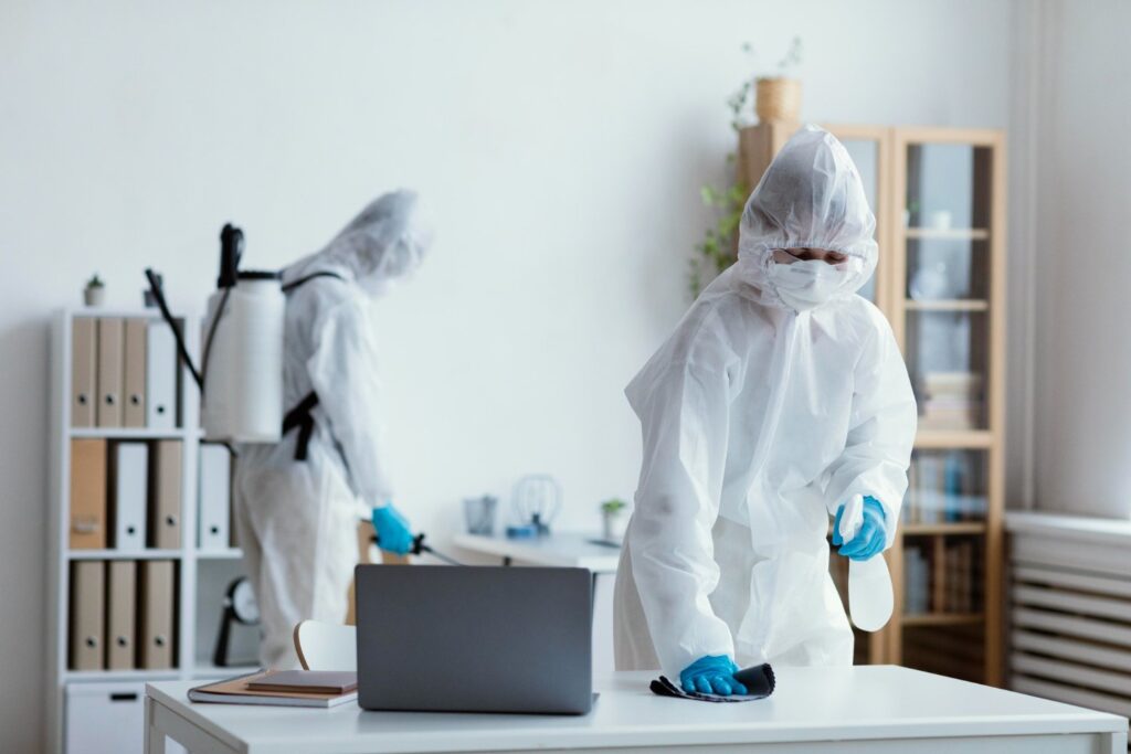 exterminator wiping down a desk